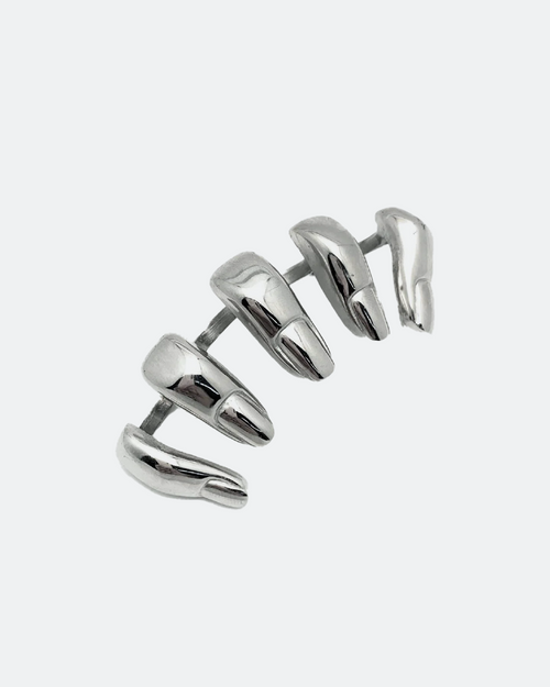 Silver knuckleduster over white background finger shapes Chris Habana