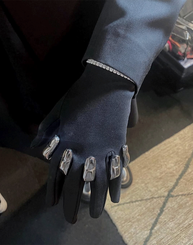 Silver knuckleduster on black gloves finger shapes Chris Habana