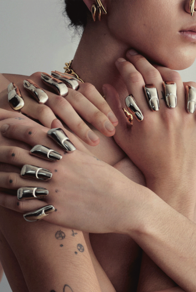 Multiple knuckledusters on person's hands finger shapes Chris Habana