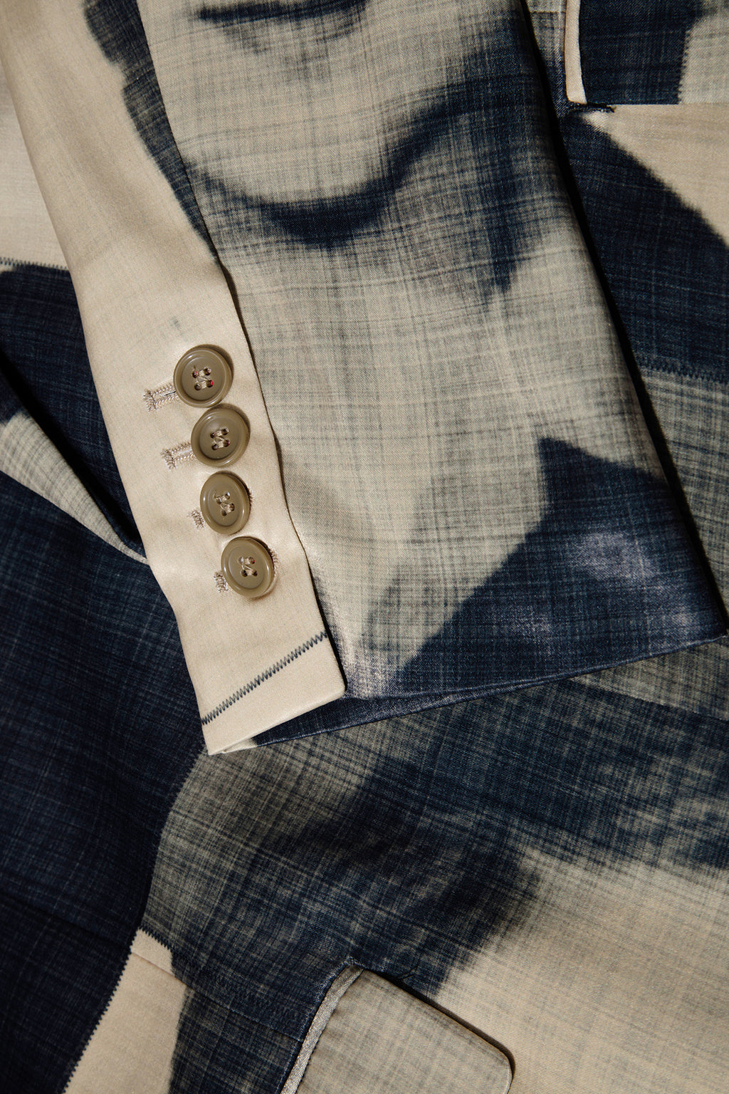 Close up of blazer with body patchwork design in creamy yellow