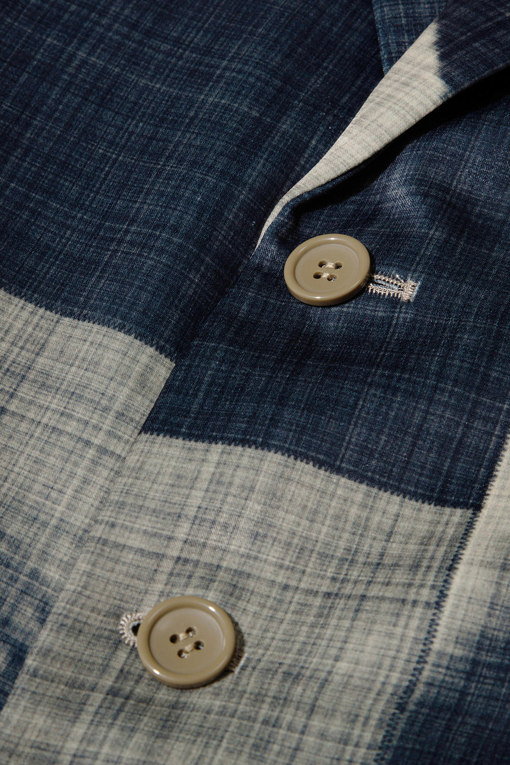 Close up of blazer with body patchwork design in creamy yellow