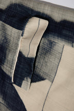 Close up of blazer with body patchwork design in creamy yellow