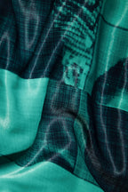 Close up of blazer with body patchwork design in green