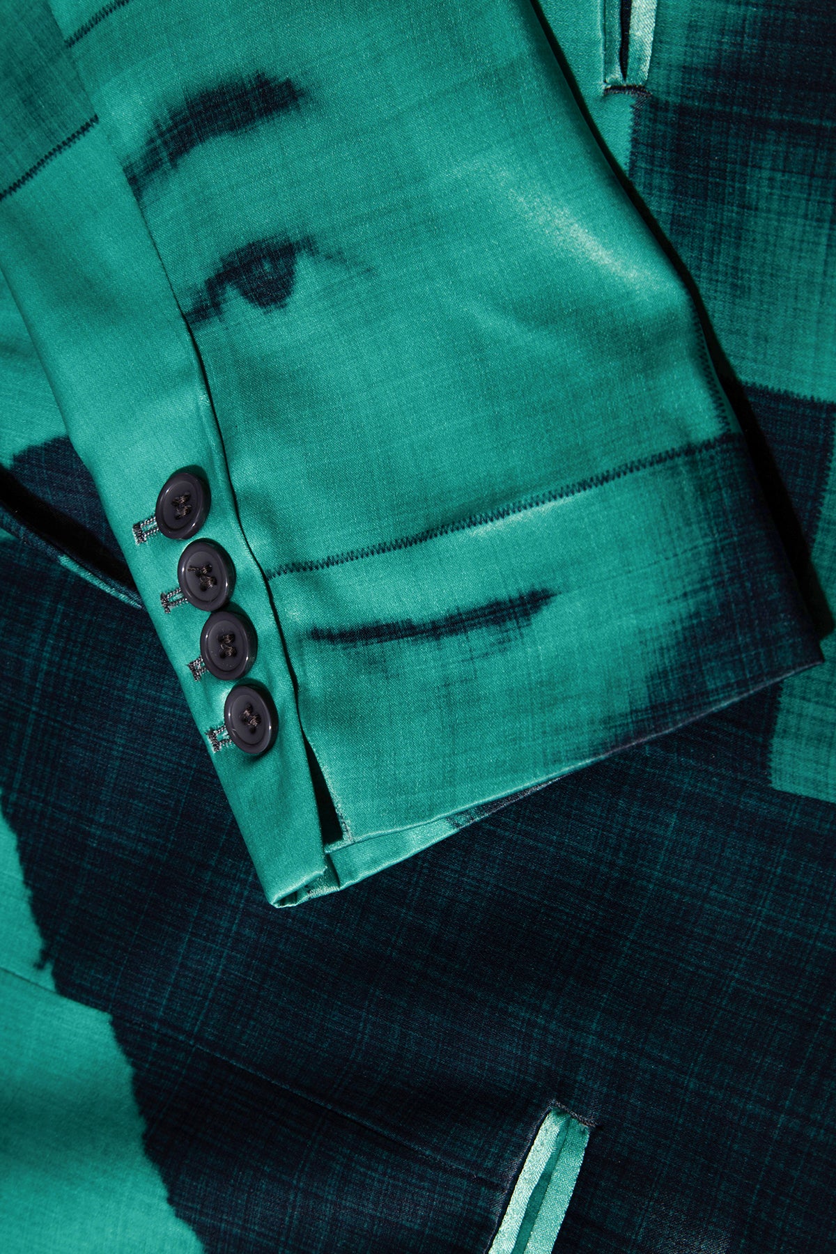 Close up of blazer with body patchwork design in green