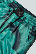 Close up of suitpants with body patchwork design in green