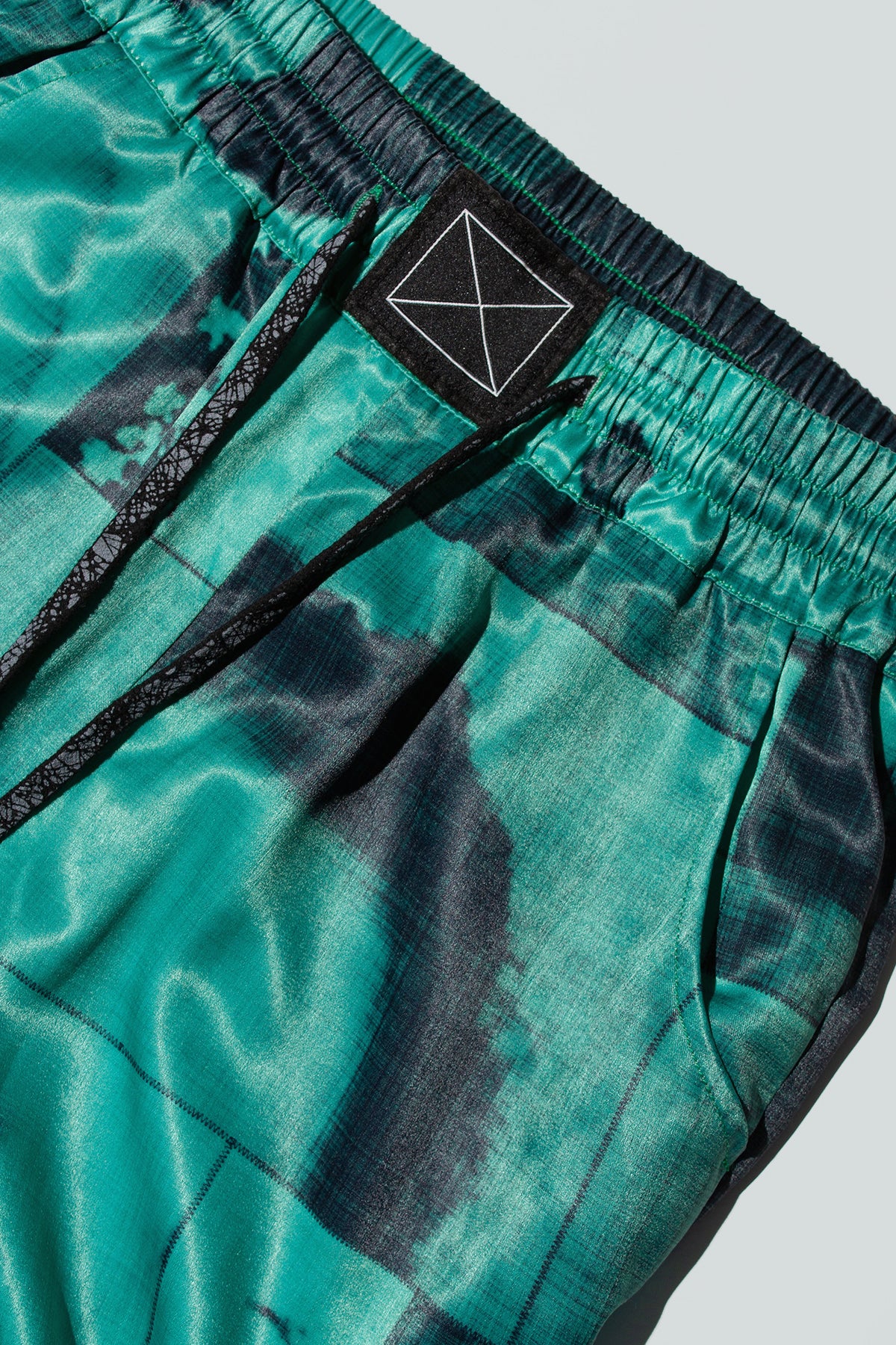 Close up of suitpants with body patchwork design in green