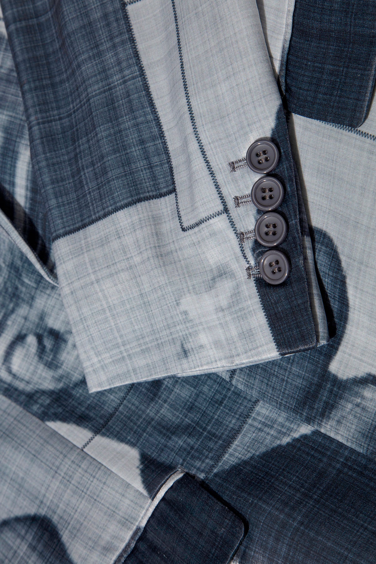 Close up of blazer with body patchwork design in grey