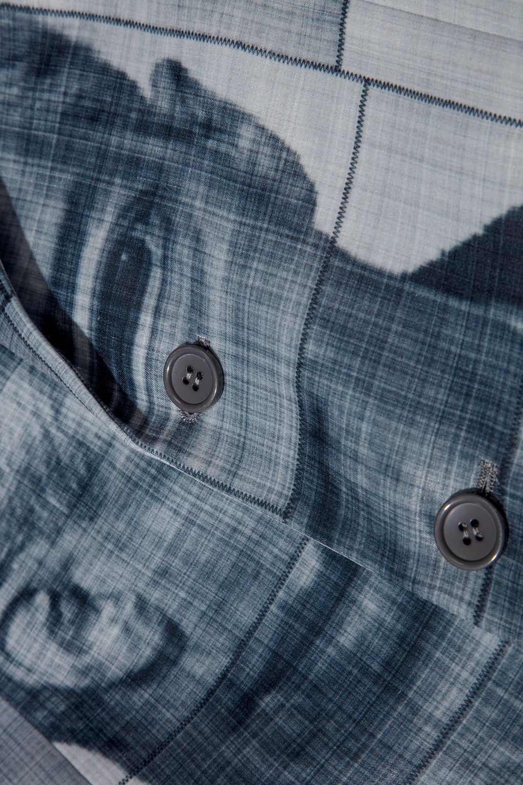 Close up of blazer with body patchwork design in grey