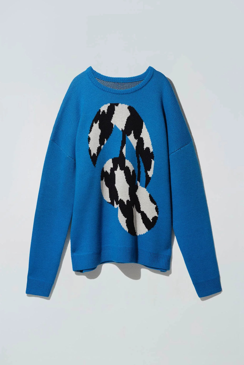 Blue sweater with a black and white graphic of a fruit cherry over a white background