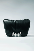 Black leather handbag with a hand silver hardware grip on a white background