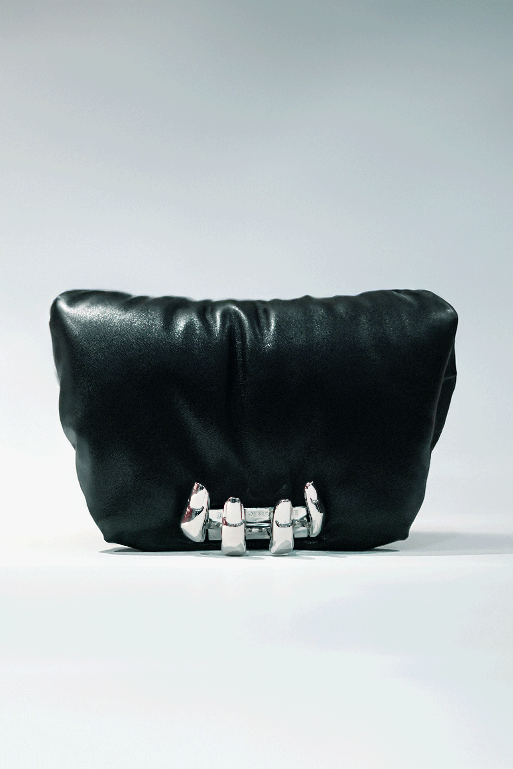 Black leather handbag with a hand silver hardware grip on a white background