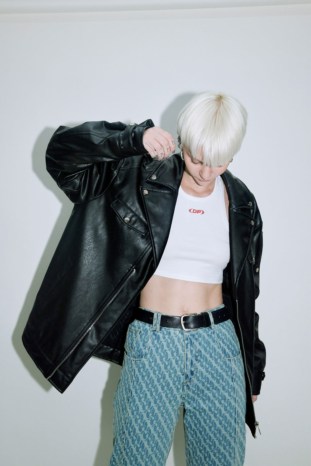 Model wearing Dirty Pineapple leather biker jacket over white background