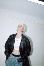 Model wearing Dirty Pineapple leather biker jacket over white background