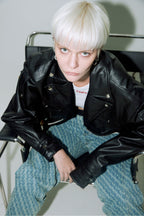 Model wearing Dirty Pineapple leather biker jacket over white background