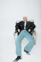 Model wearing Dirty Pineapple leather biker jacket over white background