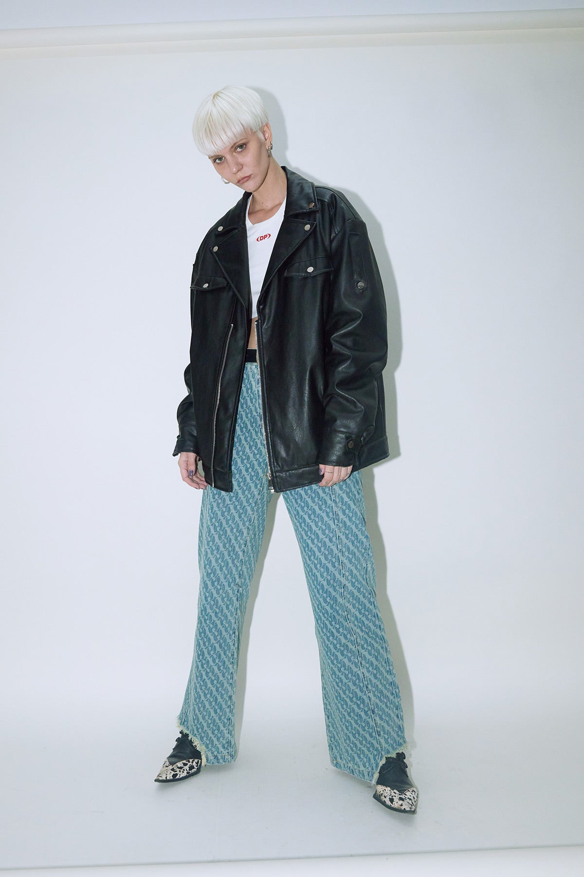 Model wearing Dirty Pineapple leather biker jacket over white background