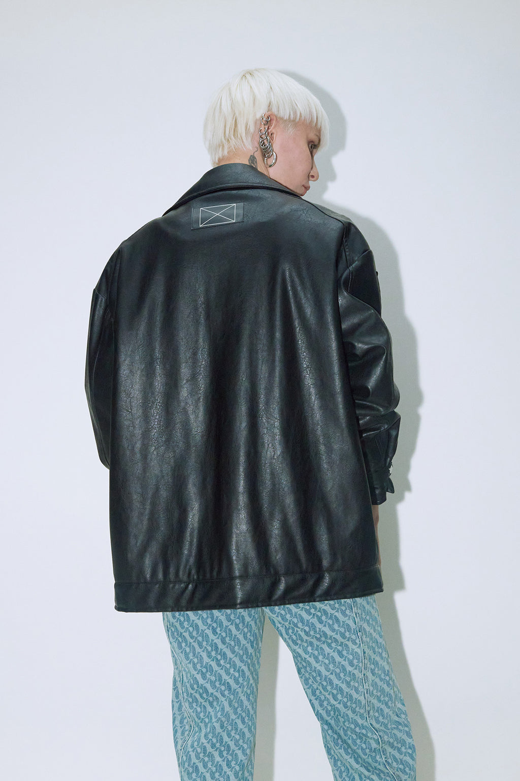 Model wearing Dirty Pineapple leather biker jacket over white background