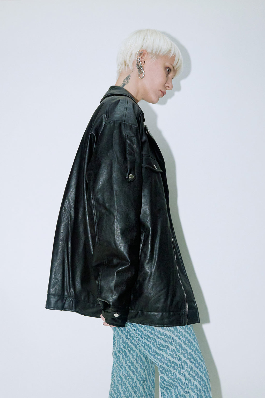 Model wearing Dirty Pineapple leather biker jacket over white background