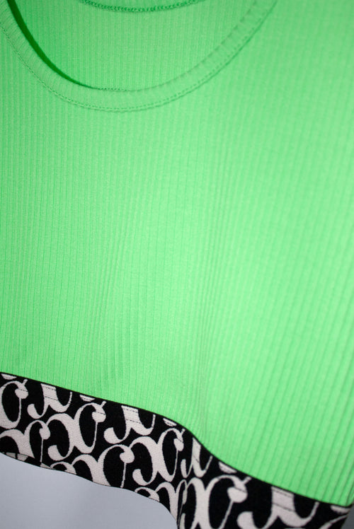 Neon green crop tank top with a black and white patterned band at the bottom