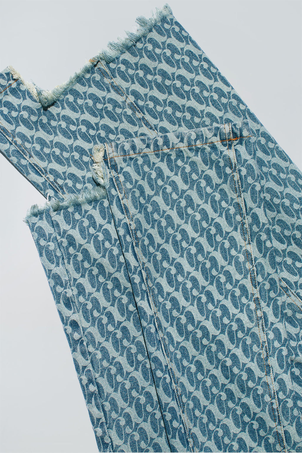 Close up of Dirty Pineapple signature patterned denim pants flare fit over white background