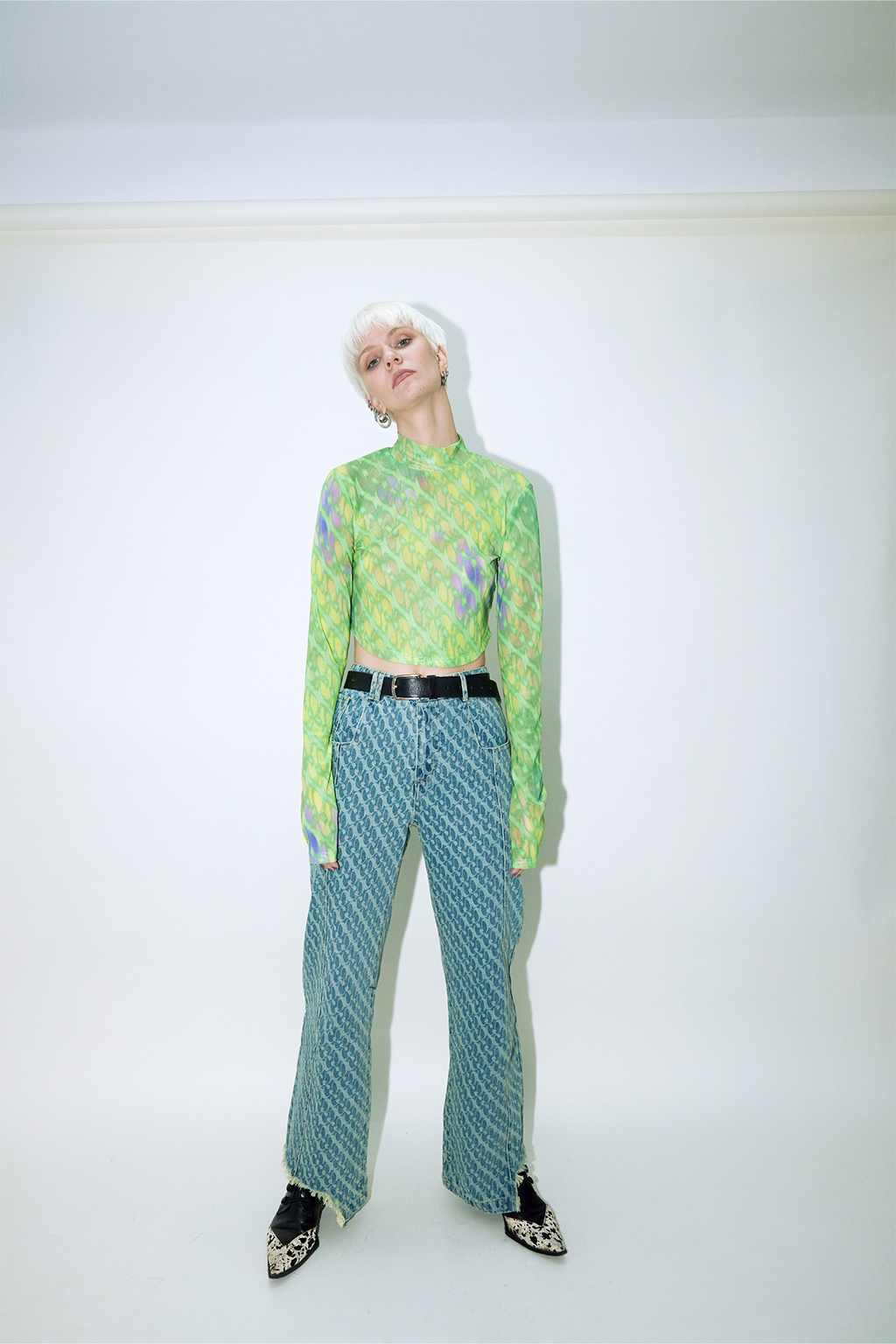 Model wearing Dirty Pineapple signature patterned denim pants straight fit over white background