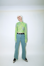 Model wearing Dirty Pineapple signature patterned denim pants straight fit over white background