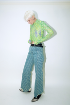 Model wearing Dirty Pineapple signature patterned denim pants straight fit over white background