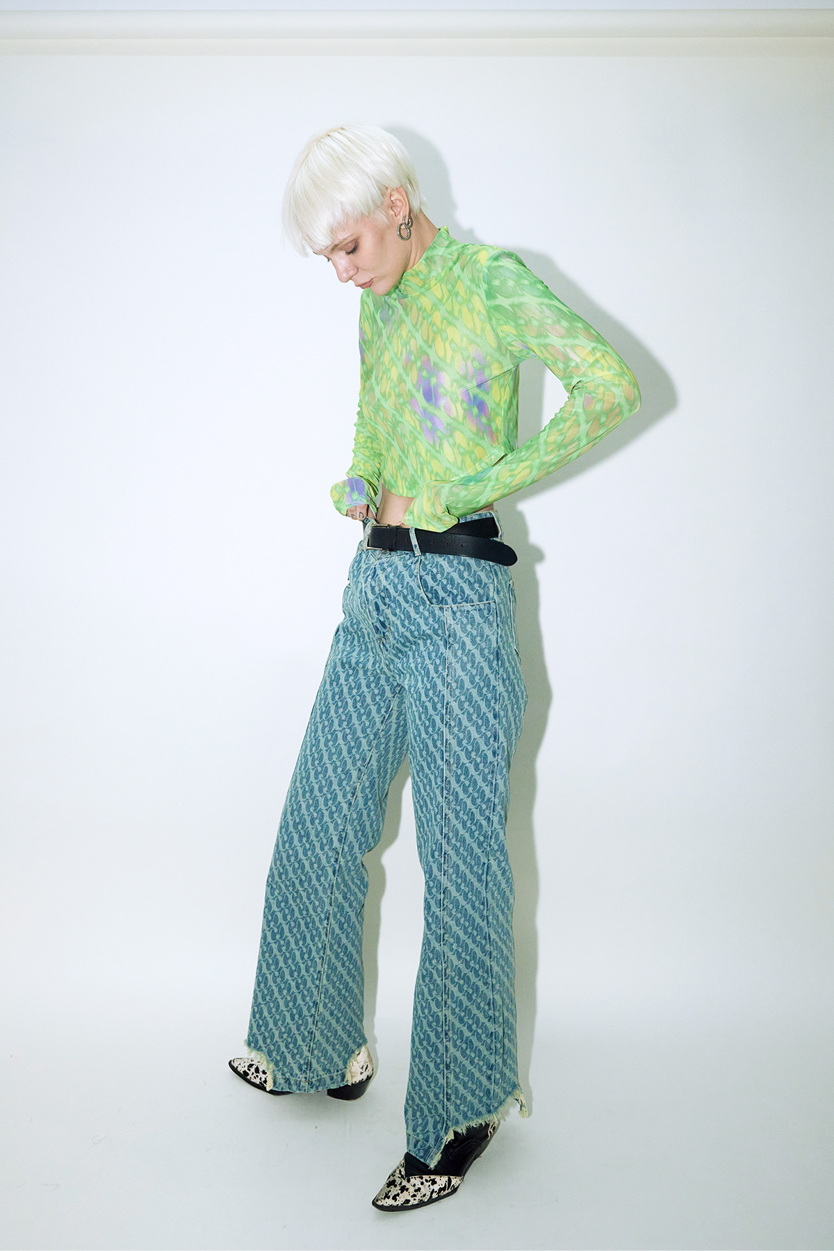 Model wearing Dirty Pineapple signature patterned denim pants straight fit over white background
