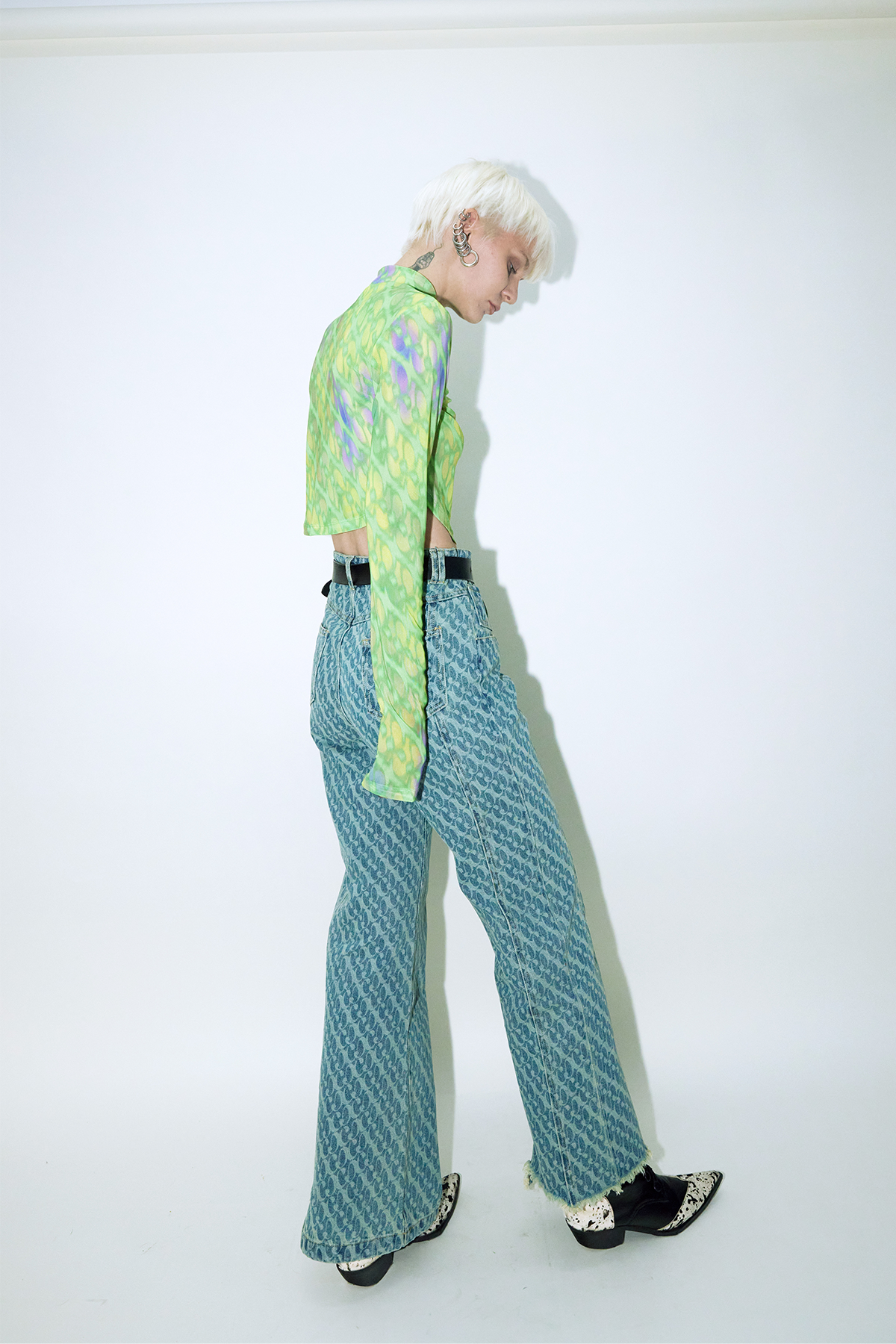 Model wearing Dirty Pineapple signature patterned denim pants straight fit over white background
