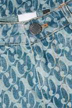 Close up of Dirty Pineapple signature patterned denim pants straight fit over white background