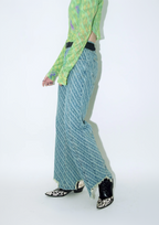 Close up of model wearing Dirty Pineapple signature patterned denim pants straight fit over white background