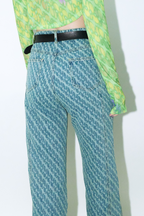 Close up of model wearing Dirty Pineapple signature patterned denim pants straight fit over white background
